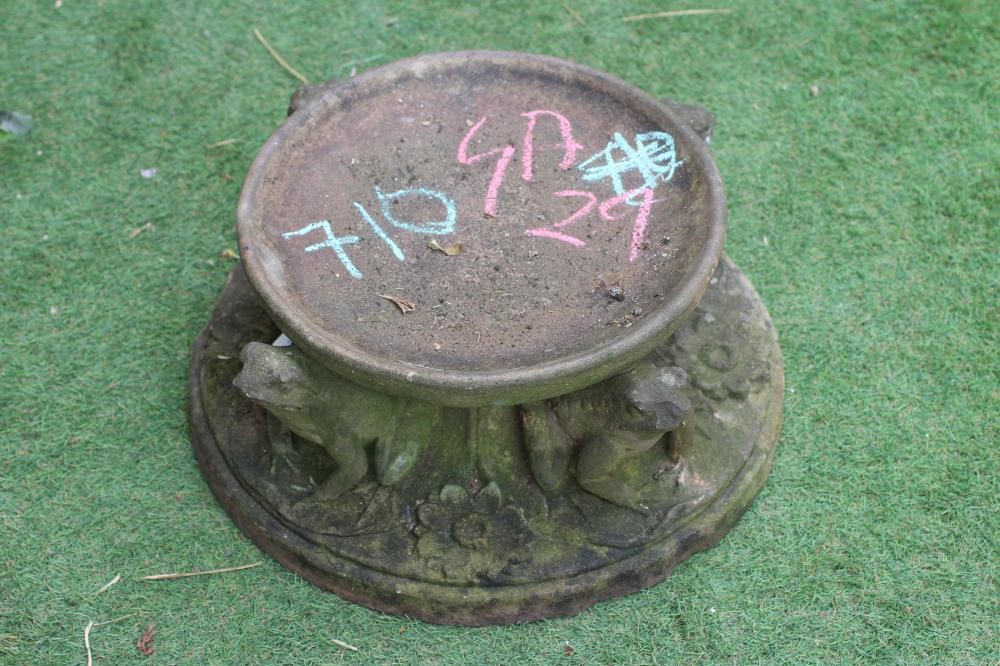 A CAST STONE BIRDBATH, the circular bowl raised on three frog supports, the mildly domed circular Image