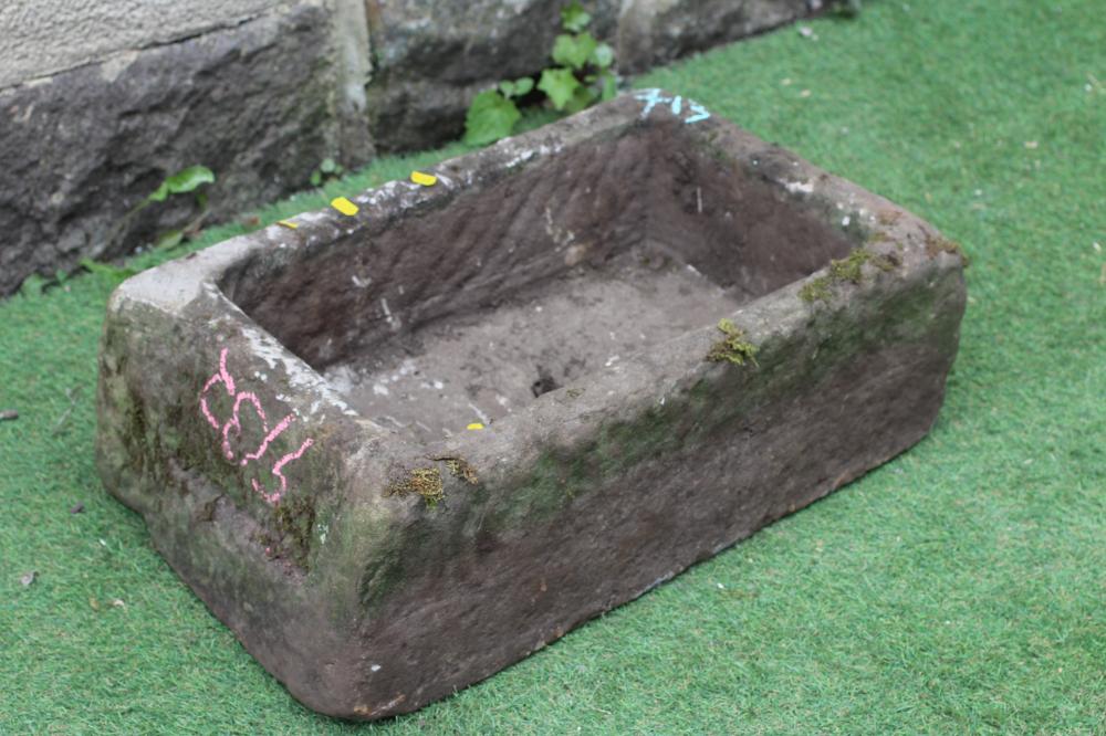 A SANDSTONE TROUGH of rough hewn oblong form, 24" w x 15" d x 8 1/2" h (Est. plus 24% premium inc. Image