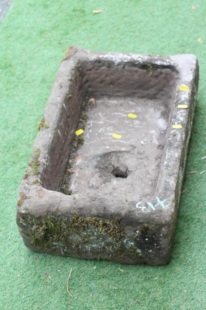 A SANDSTONE TROUGH of rough hewn oblong form, 24" w x 15" d x 8 1/2" h (Est. plus 24% premium inc. Image
