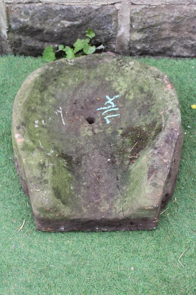 A SANDSTONE WATER FEATURE of horseshoe open ended form with small central aperture, 21 1/2" w x 18" Image