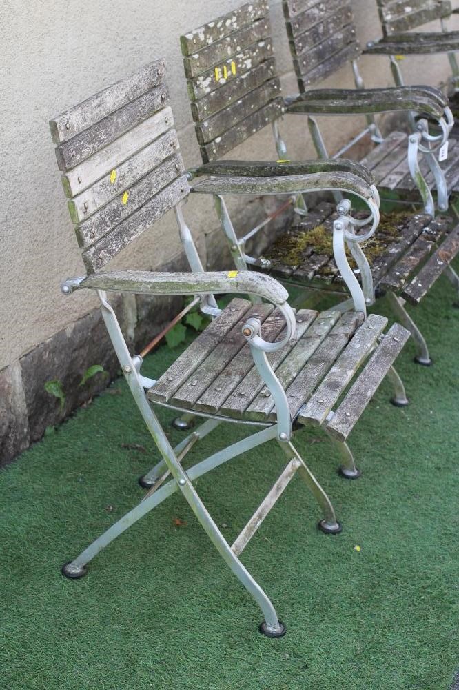 A SET OF FOUR BISTRO FOLDING ARMCHAIRS, the slatted wood seat and back on a metal frame, 22" w x 15 Image