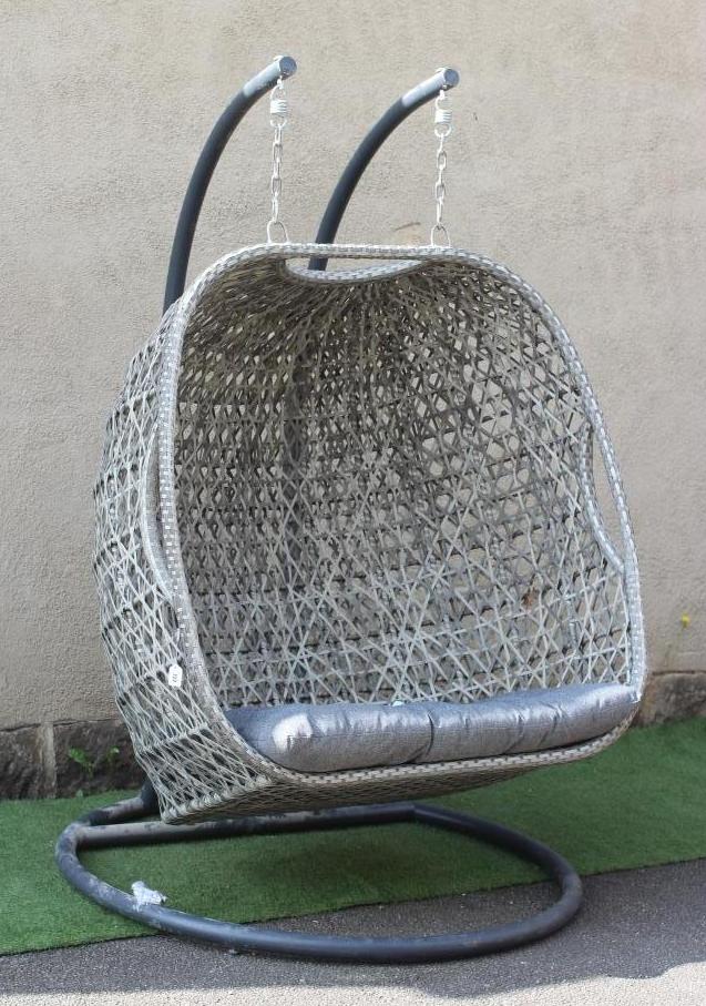 A POLYRATTAN EGG CHAIR, modern, suspended by chain from a tubular metal frame with circular base, 51 Image