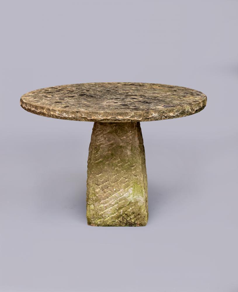A SANDSTONE TABLE, the shallow circular top raised on square tapering stem, 41 1/2" w x 29" h Image