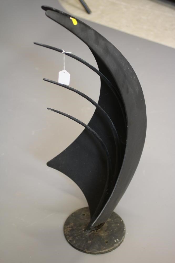 A BLACK PATINATED METAL ABSTRACT SCULPTURE, modern, of curved angular form set on a circular base, Image