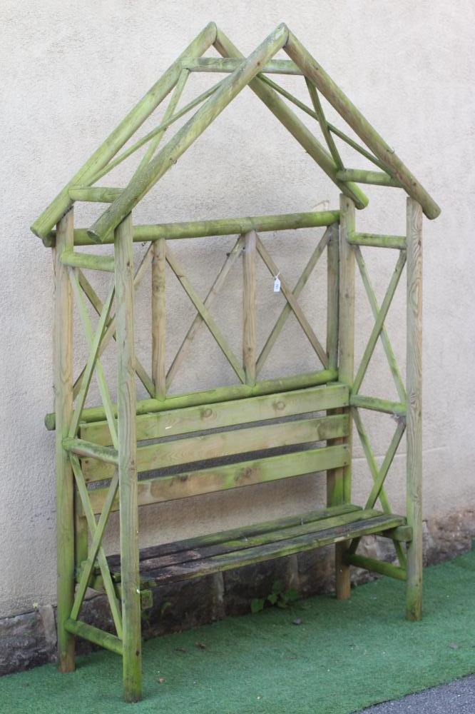 A TWO SEATER SOFT WOOD ARBOUR with arched top and trellis sides, 58 1/2" w x 20" d x 88" h Image