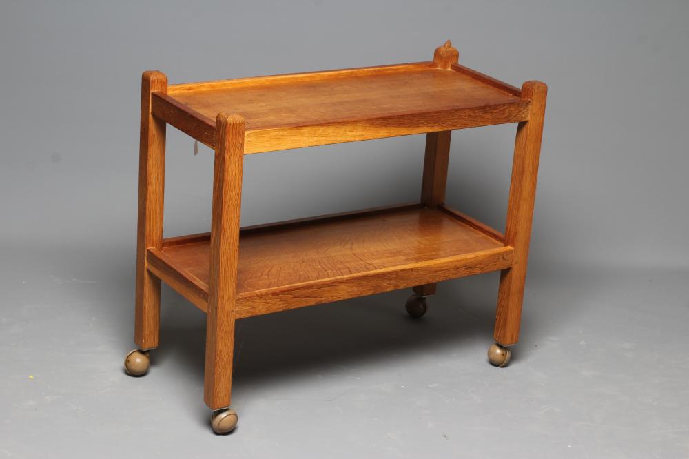 ROBERT THOMPSON - AN OAK TWO TIER OBLONG TEA TROLLEY with square supports and castors, carved mouse Image