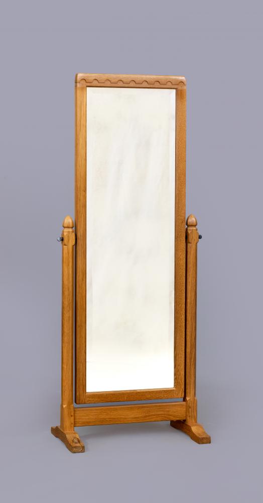 ROBERT THOMPSON - AN ADZED OAK CHEVAL MIRROR Image