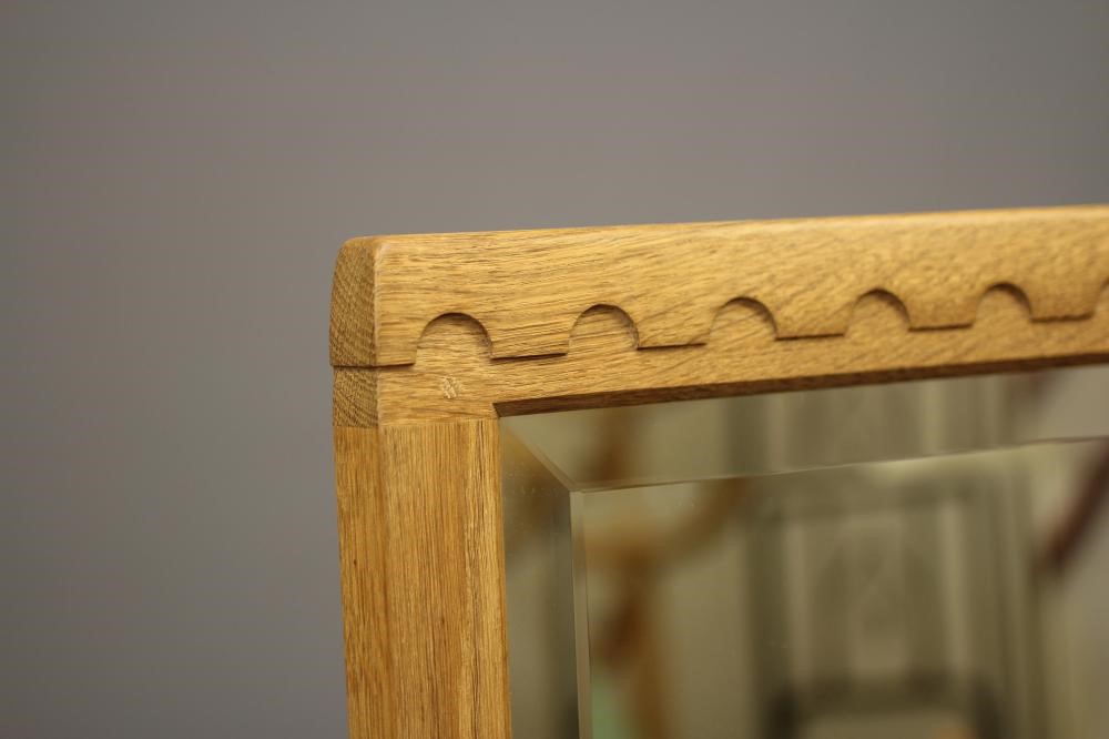 ROBERT THOMPSON - AN ADZED OAK CHEVAL MIRROR Image