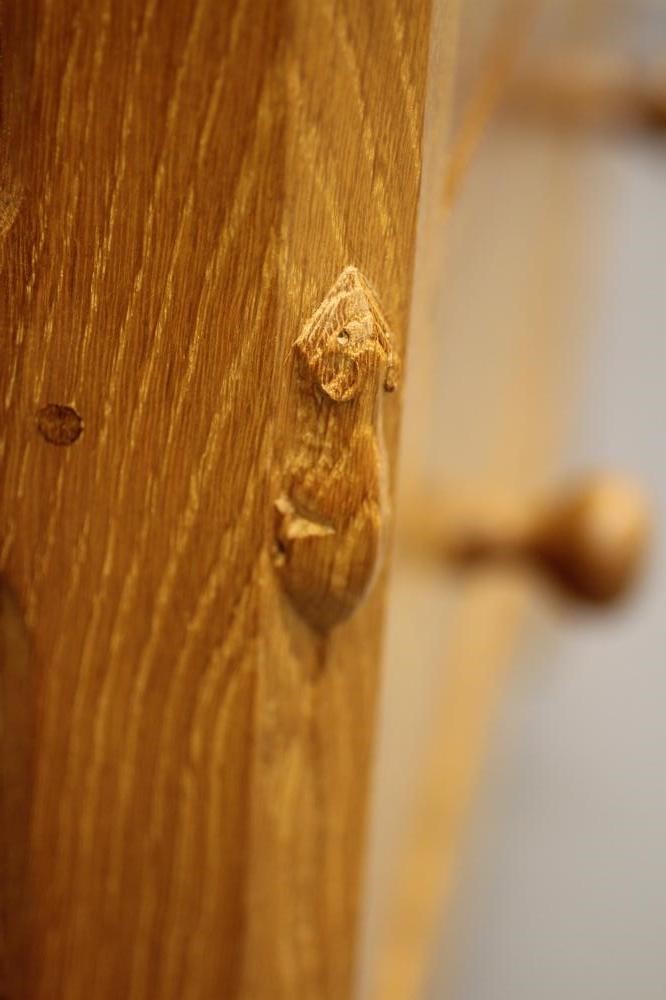 ROBERT THOMPSON - AN ADZED OAK BEDSIDE CHEST of canted oblong form Image