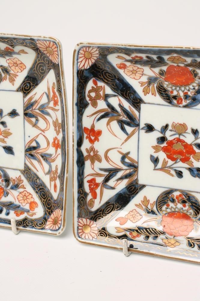 A PAIR OF IMARI PORCELAIN SQUARE DISHES painted in typical palette with panels of iris and potted Image