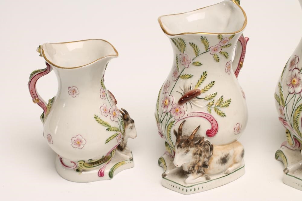 A GRADUATED SET OF THREE CONTINENTAL PORCELAIN "GOAT AND BEE" JUGS Image