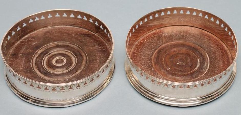 A LATE GEORGE III SILVER BOTTLE COASTER Image