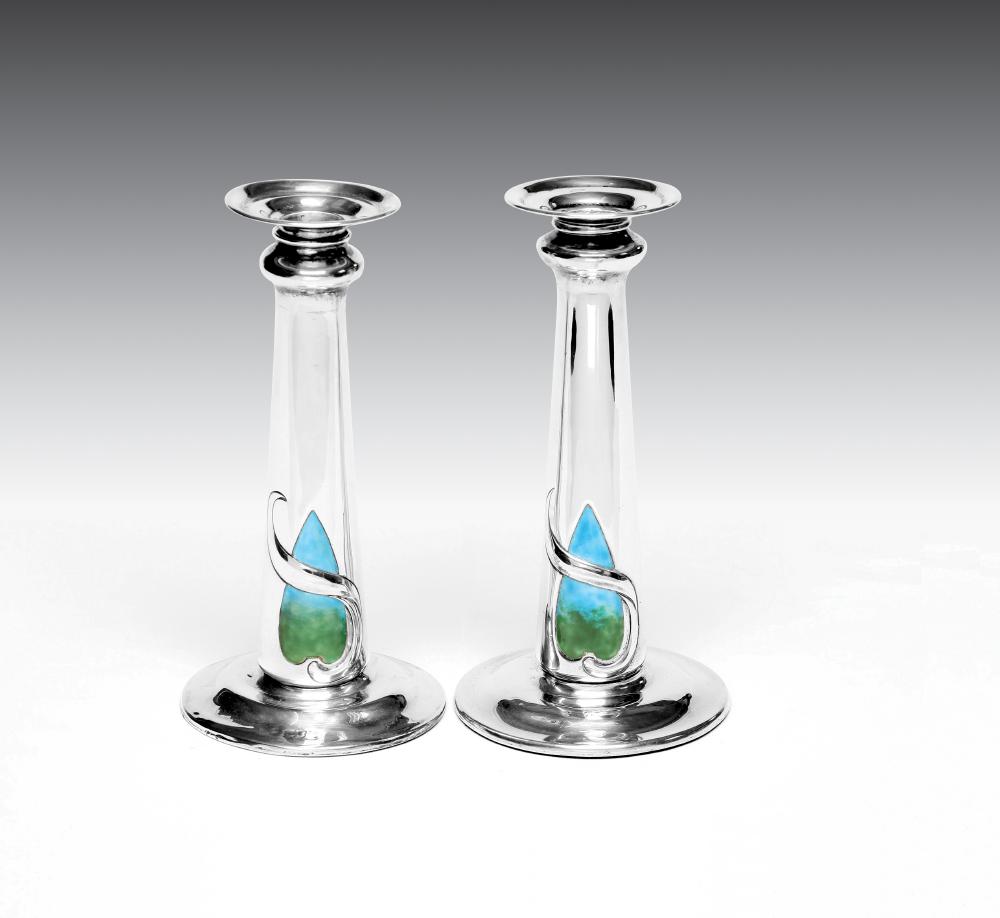 A PAIR OF EDWARDIAN ARTS AND CRAFTS SILVER AND ENAMEL CANDLESTICKS Image