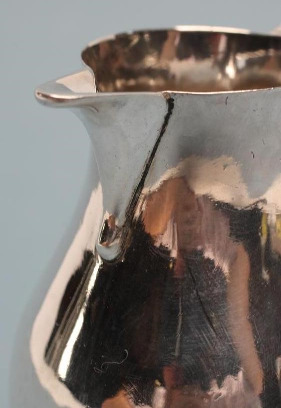 A GEORGE II SILVER SPARROW BEAK CREAM JUG Image
