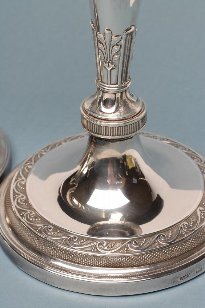 A COMPOSITE PAIR OF LATE GEORGE III SILVER CANDLESTICKS Image