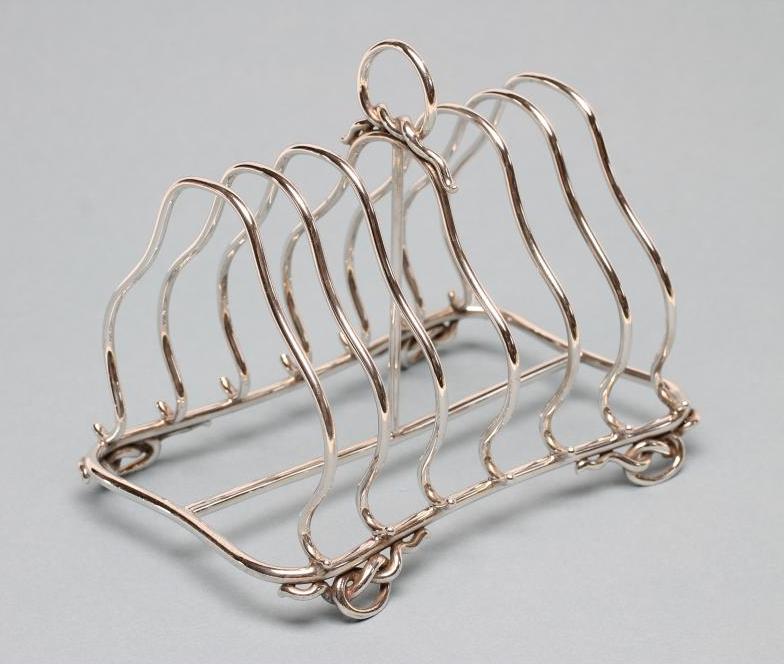 A VICTORIAN SILVER SEVEN BAR WIREWORK TOASTRACK Image