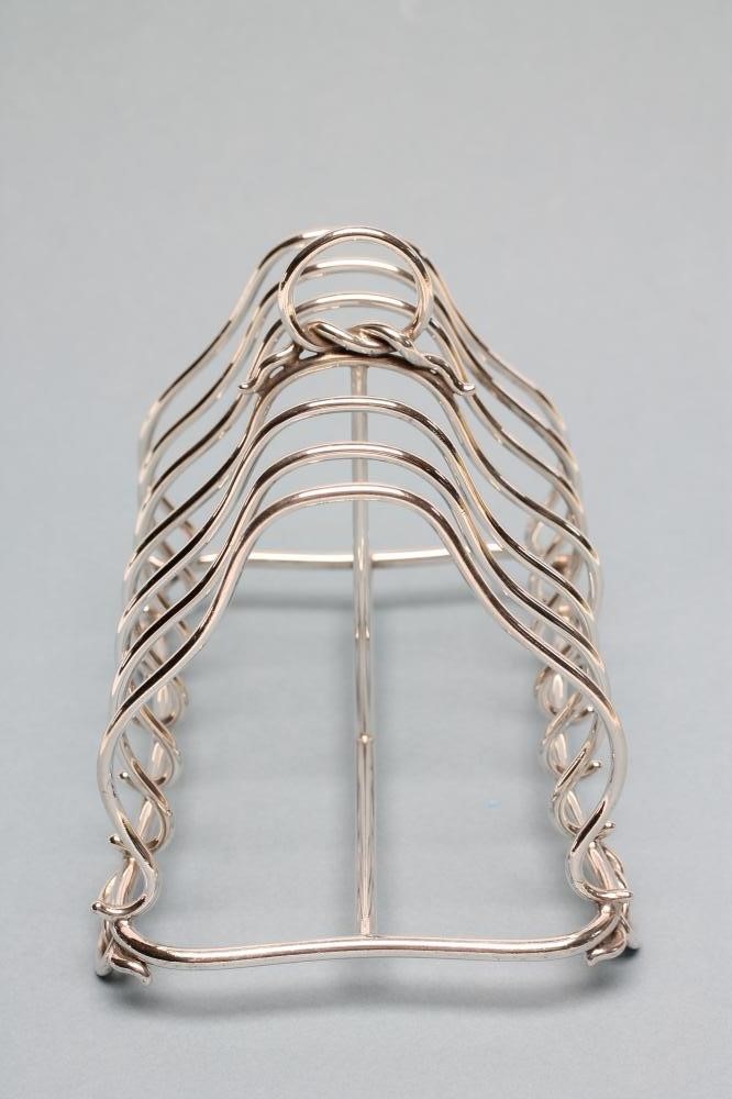 A VICTORIAN SILVER SEVEN BAR WIREWORK TOASTRACK Image