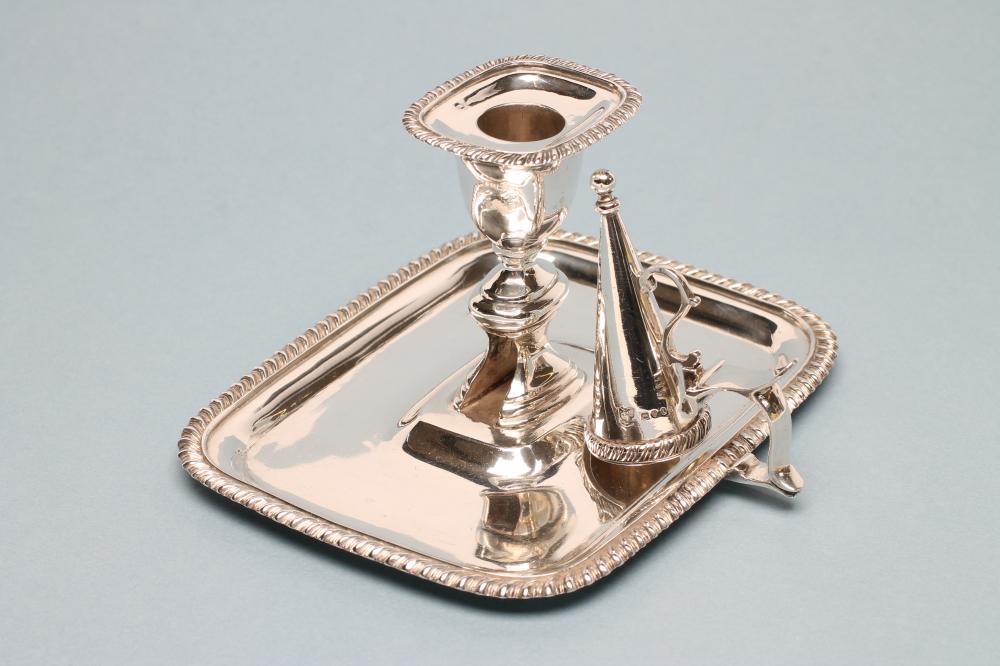 A VICTORIAN SILVER CHAMBERSTICK AND CONICAL SNUFFER Image