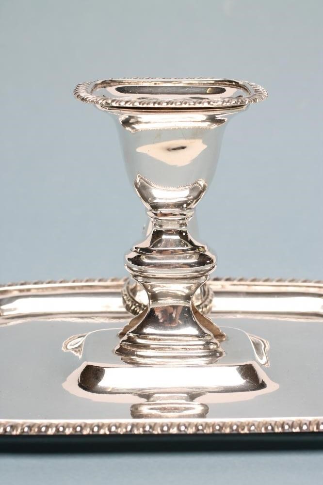 A VICTORIAN SILVER CHAMBERSTICK AND CONICAL SNUFFER Image