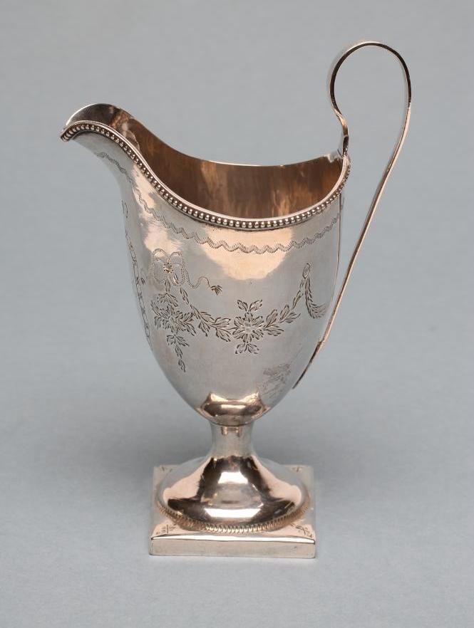 A LATE GEORGE III SILVER HELMET JUG Image