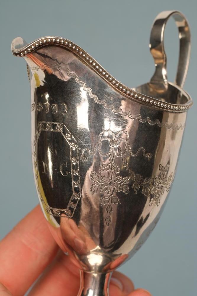 A LATE GEORGE III SILVER HELMET JUG Image