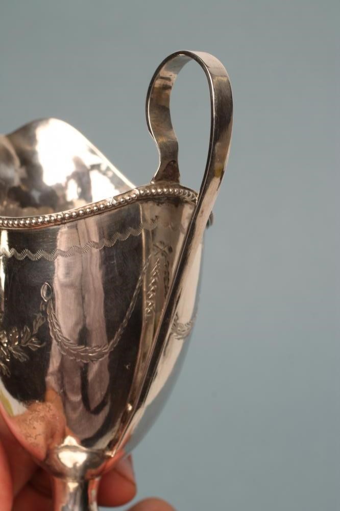 A LATE GEORGE III SILVER HELMET JUG Image