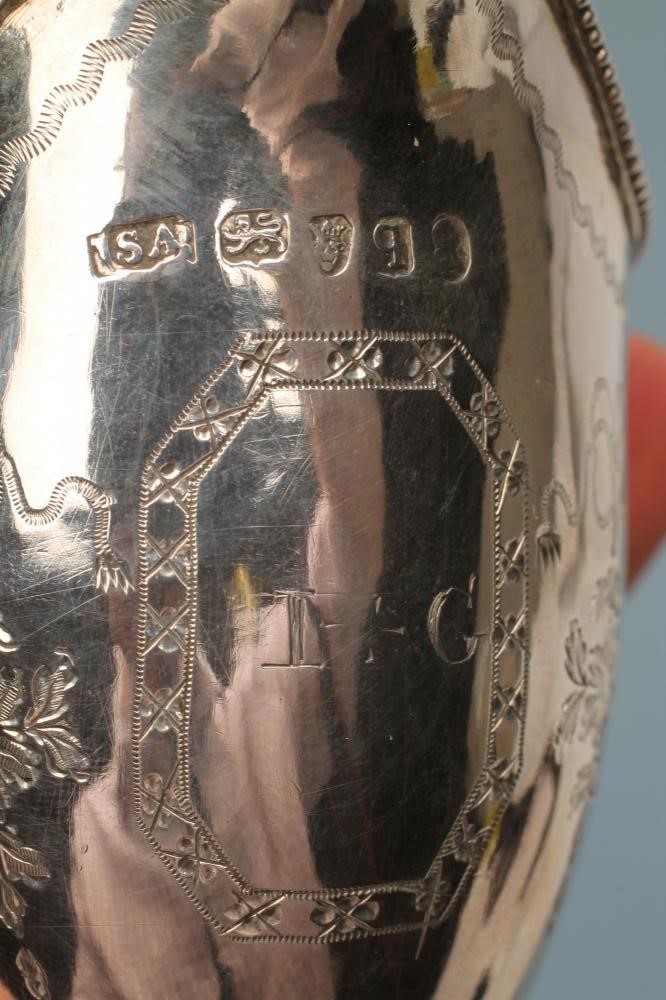 A LATE GEORGE III SILVER HELMET JUG Image