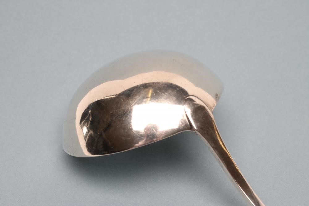A LATE GEORGE III SILVER SOUP LADLE Image
