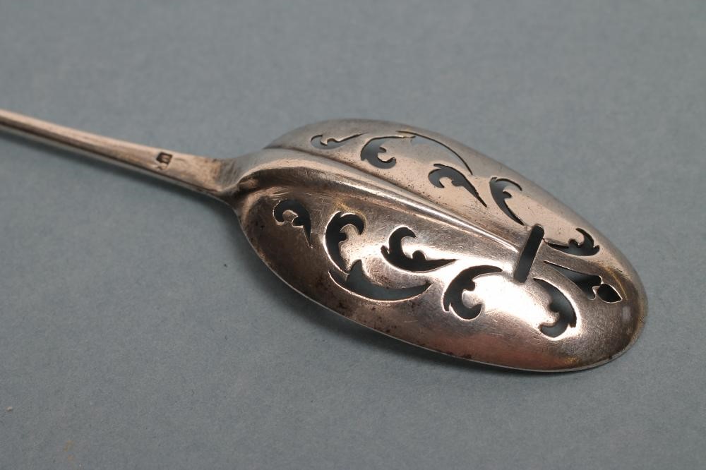 A GEORGE III SILVER MOTE SPOON Image