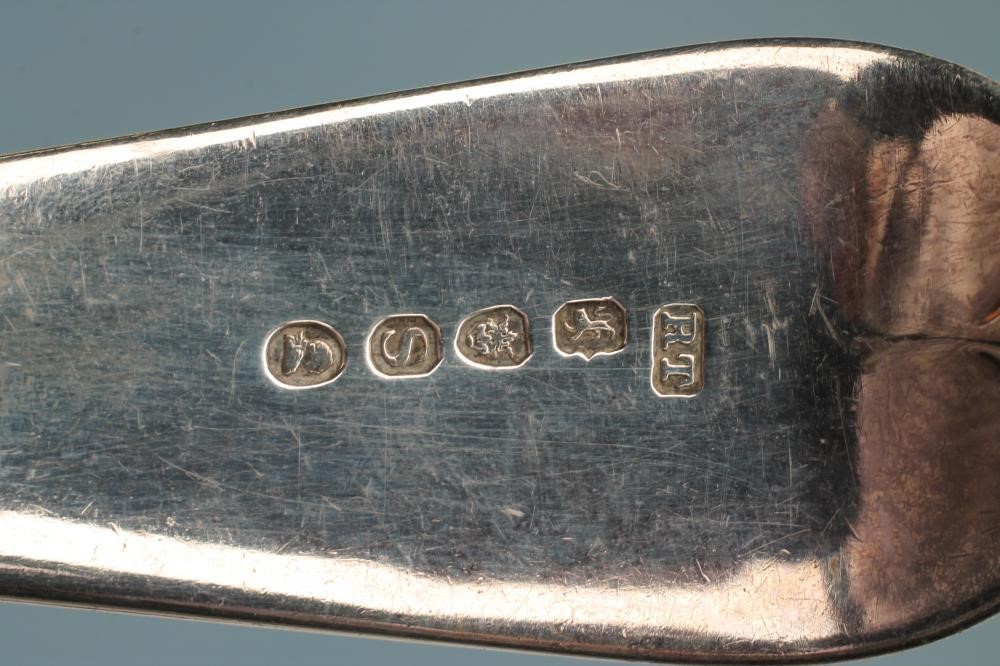 A LATE GEORGE III SILVER SOUP LADLE Image