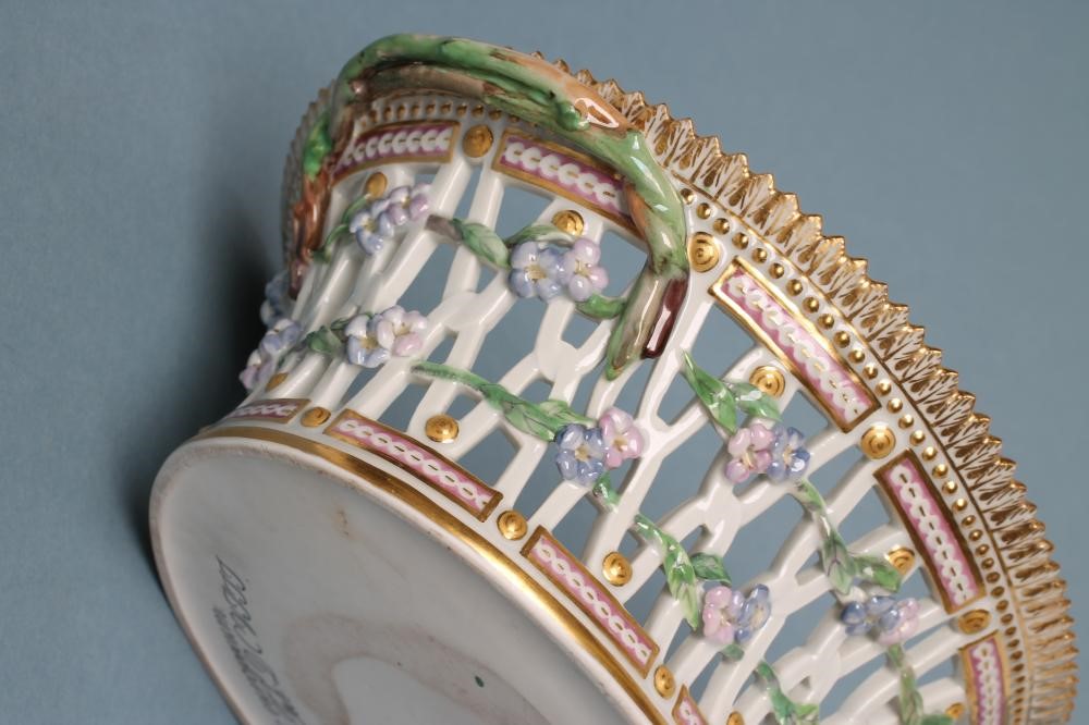 A ROYAL COPENHAGEN PORCELAIN "FLORA DANICA" BASKET of flared oval form with two naturalistic twig Image