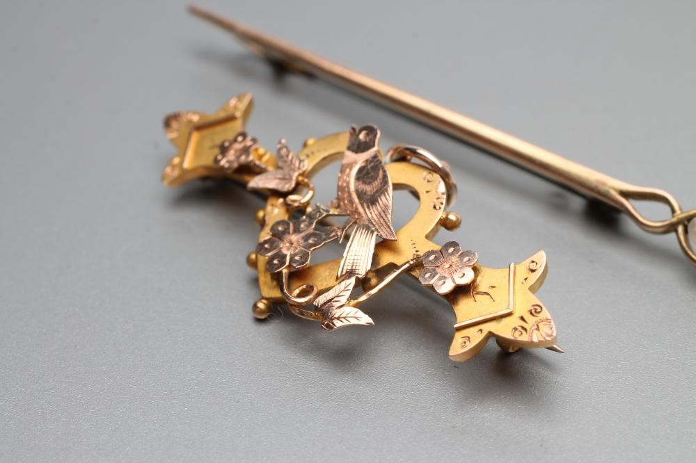 A BI-COLOURED SWEETHEART BROOCH centred by an open heart surmounted by a finch perched upon Image