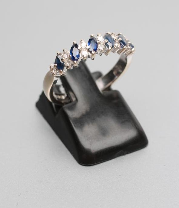 A SAPPHIRE AND DIAMOND HALF HOOP ETERNITY RING Image