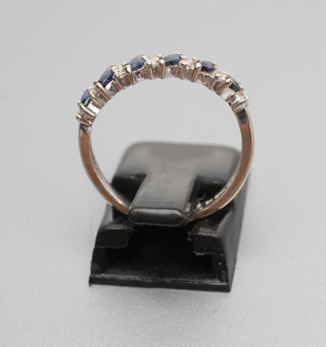 A SAPPHIRE AND DIAMOND HALF HOOP ETERNITY RING Image