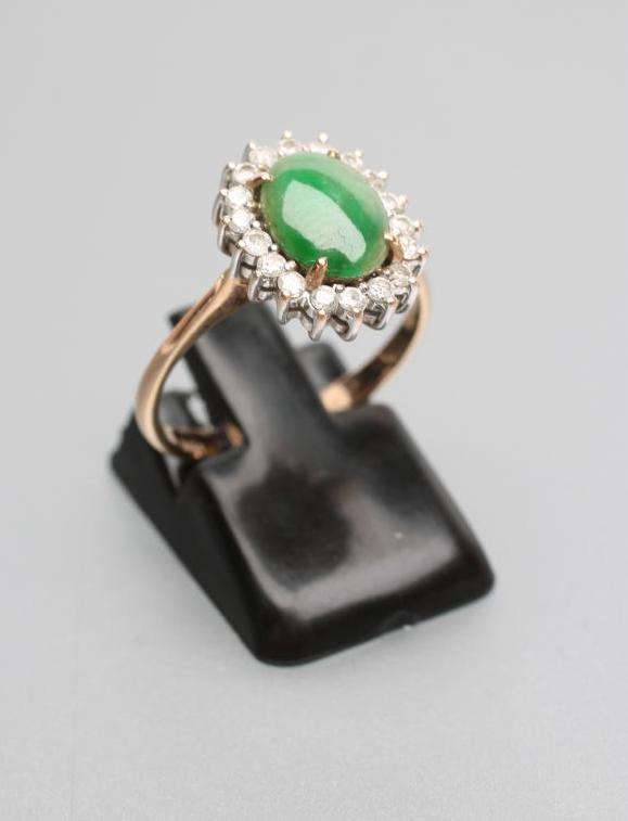 A JADE AND DIAMOND OVAL CLUSTER RING Image