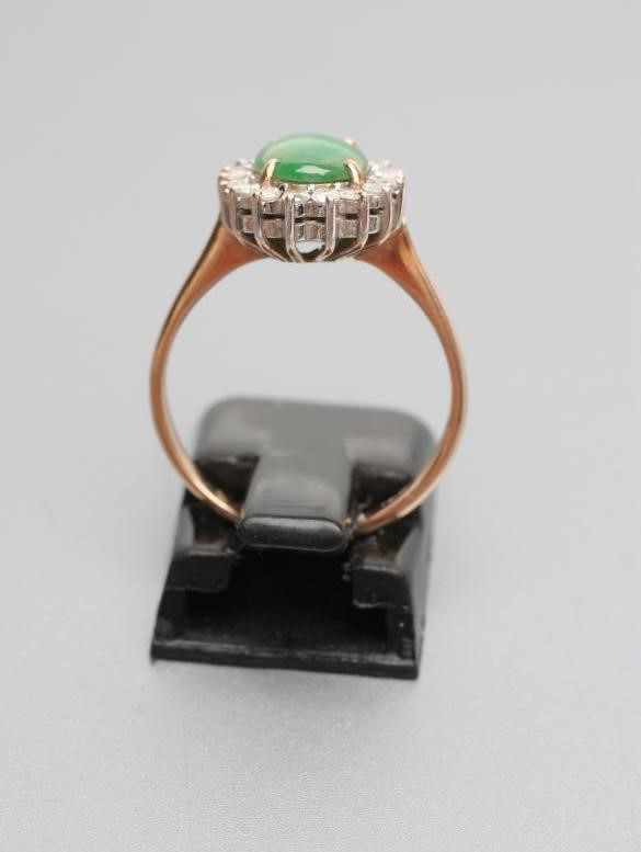 A JADE AND DIAMOND OVAL CLUSTER RING Image