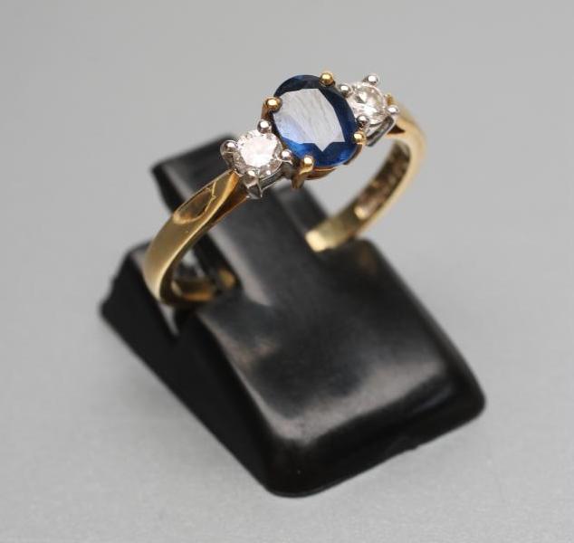 A SAPPHIRE AND DIAMOND THREE STONE RING Image
