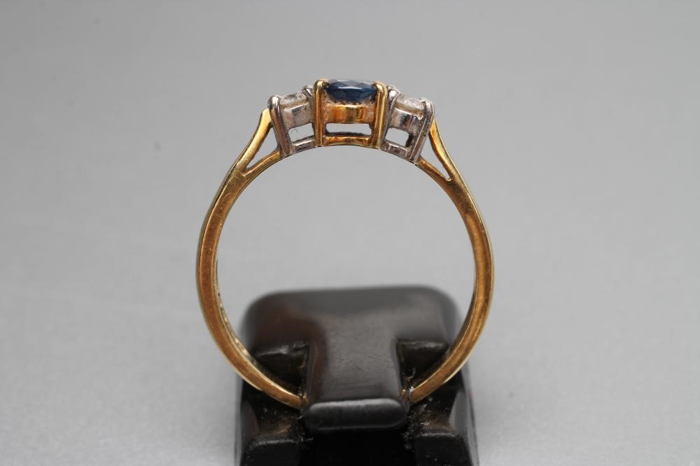 A SAPPHIRE AND DIAMOND THREE STONE RING Image
