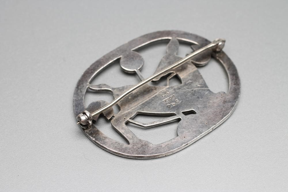 A GEORG JENSEN "KNEELING DEER" SILVER BROOCH designed by Arno Malinowski Image