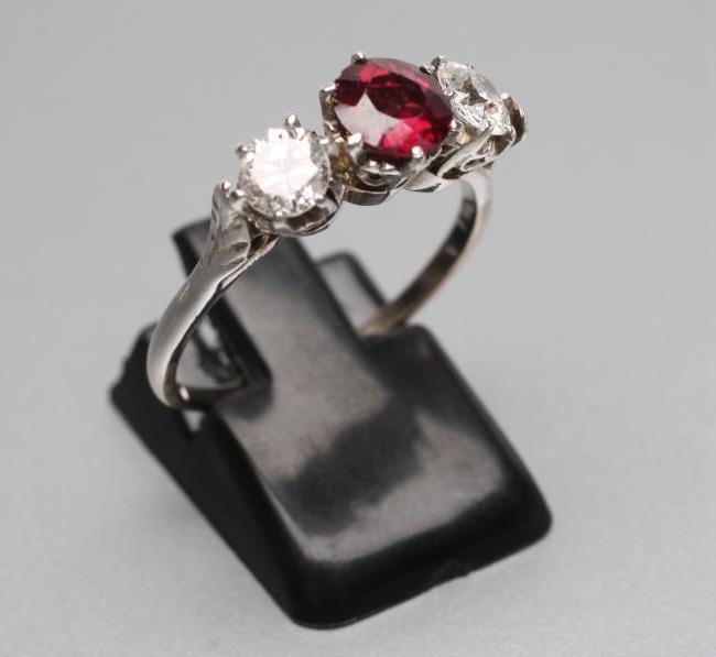 A RUBY AND DIAMOND THREE STONE RING Image