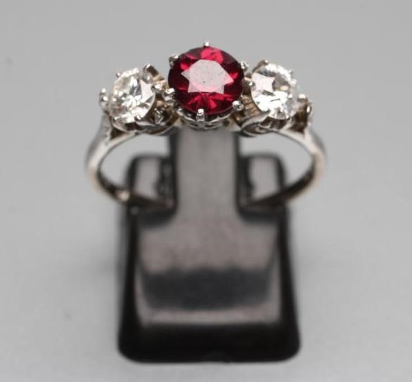A RUBY AND DIAMOND THREE STONE RING Image