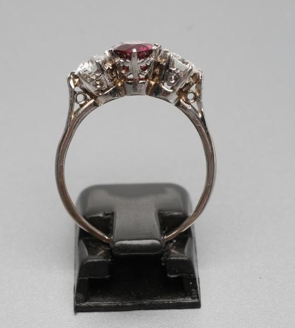 A RUBY AND DIAMOND THREE STONE RING Image