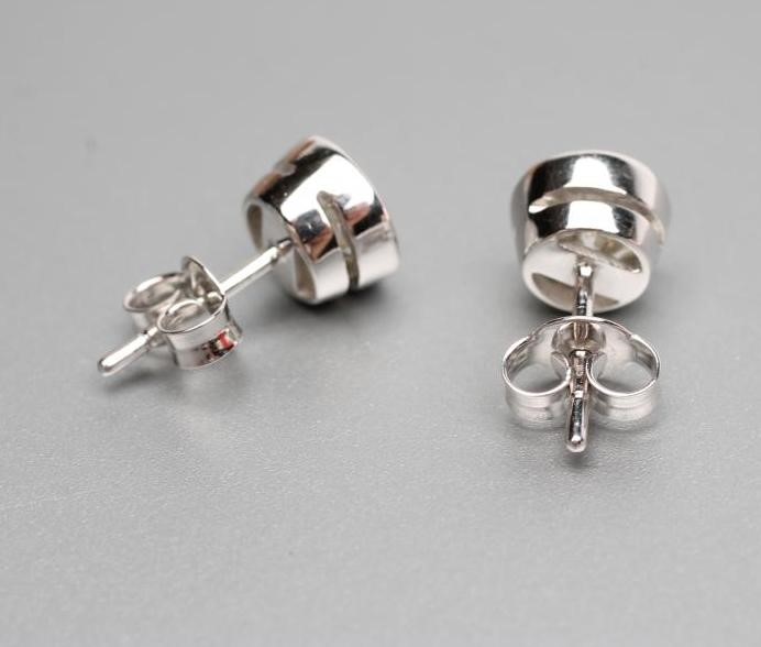 A PAIR OF SOLITAIRE MOISSANITE EAR STUDS Image