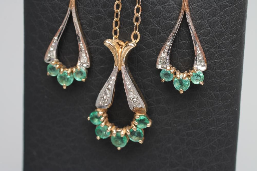 AN EMERALD AND DIAMOND PENDANT WITH MATCHING DROP EAR STUDS Image