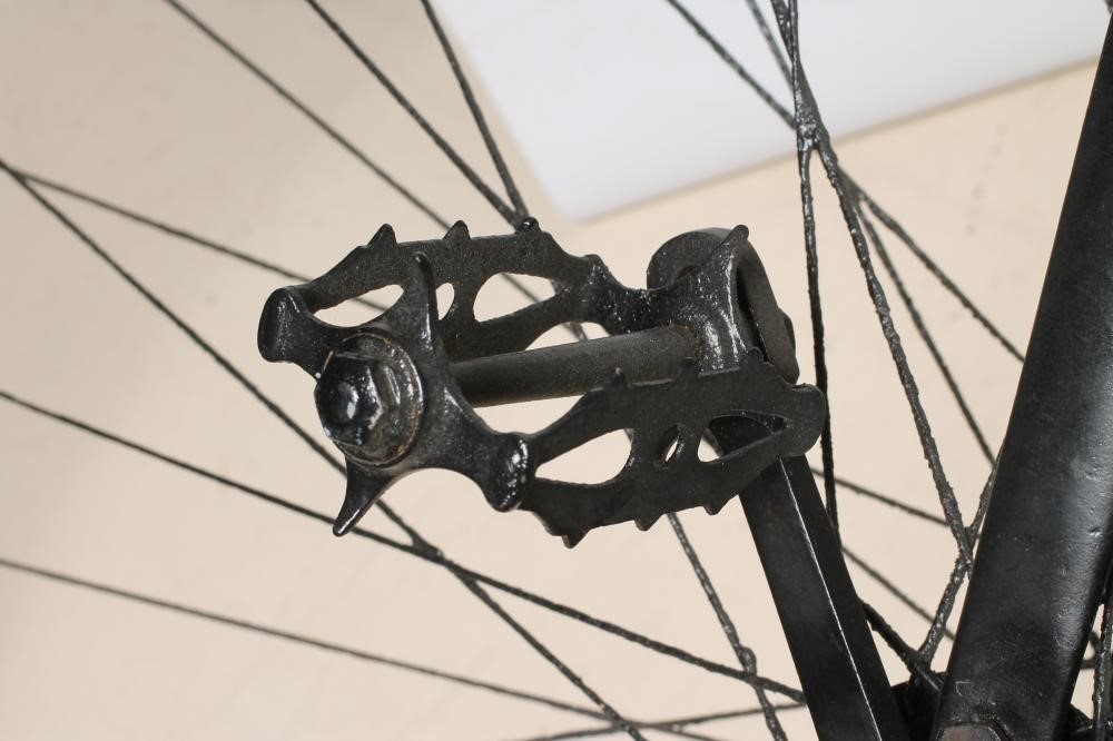 A PENNY FARTHING BICYCLE with stamped metal seat Image