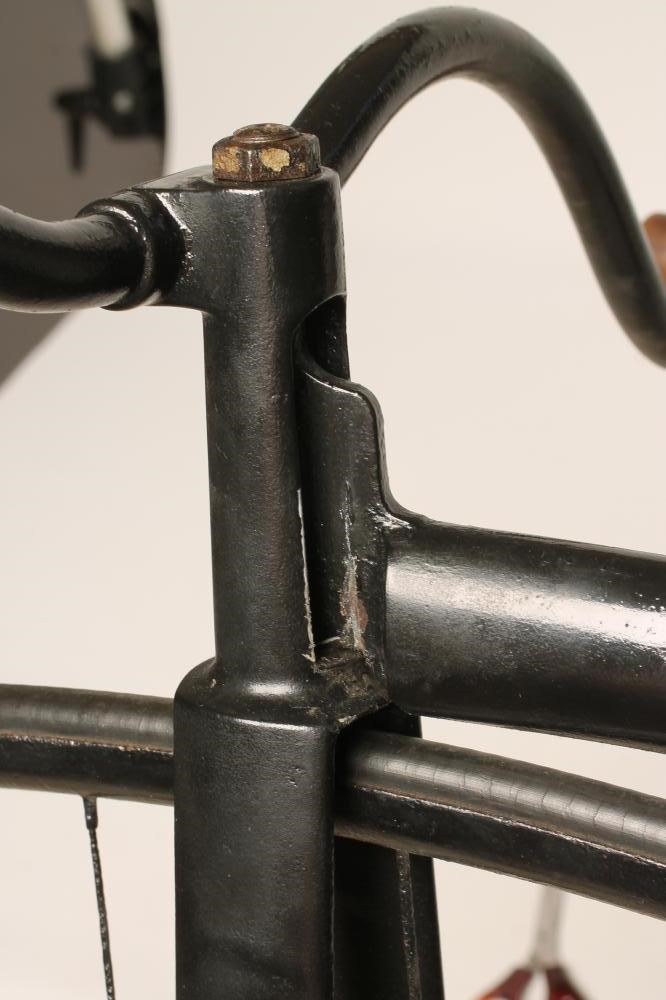 A PENNY FARTHING BICYCLE with stamped metal seat Image