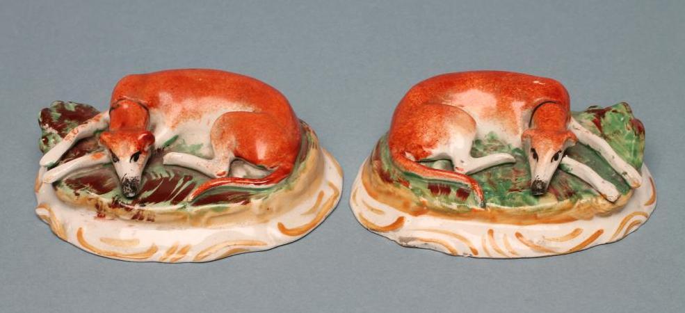 A PAIR OF STAFFORDSHIRE POTTERY GREYHOUNDS Image