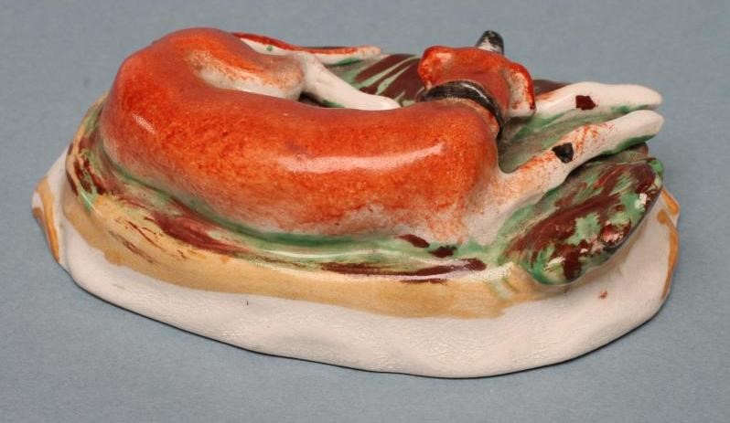 A PAIR OF STAFFORDSHIRE POTTERY GREYHOUNDS Image