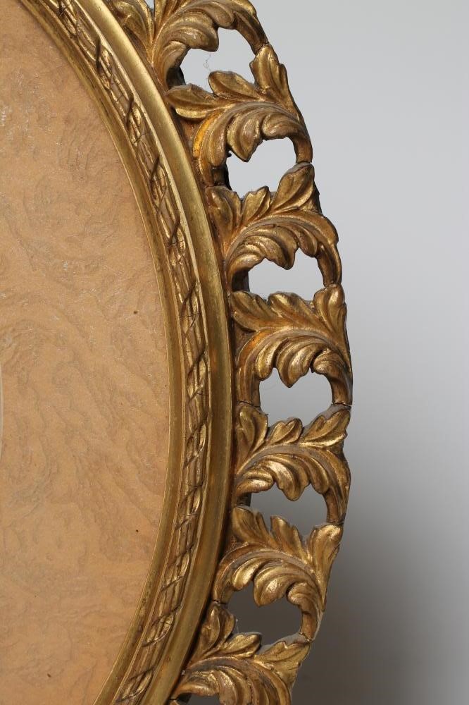 AN EDWARDIAN OPAQUE GLASS OVAL PANEL painted with the half length portrait of a young lady wearing a Image