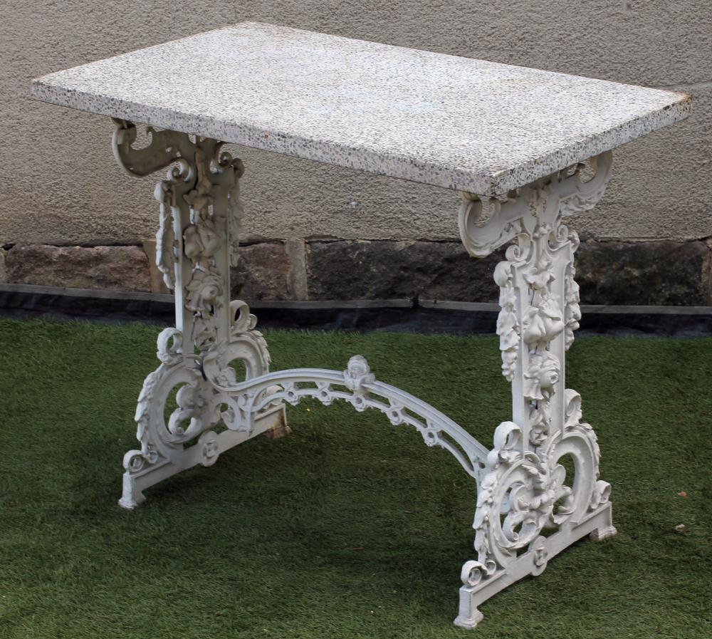 A VICTORIAN CAST IRON PUB TABLE of oblong form with composite stone top on pierced and moulded Image